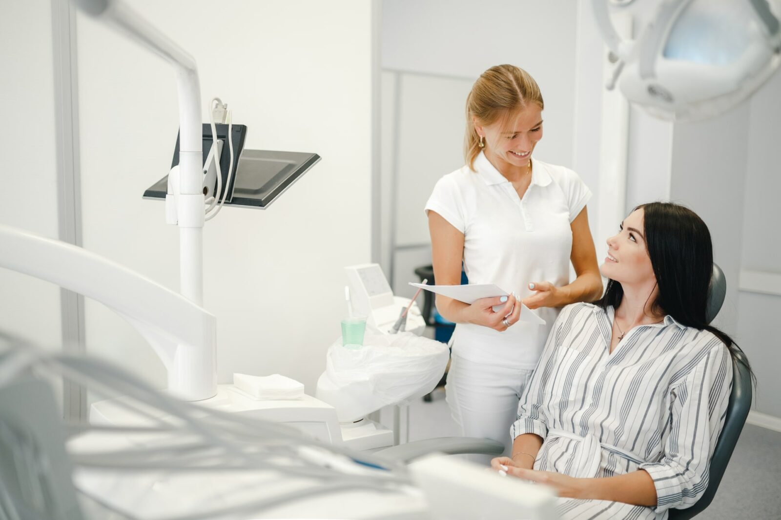 Female dentist talking with patient